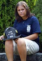 Tara Feinberg holds the helmet of lost firefighter dad Alan