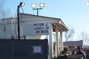 A sign hanging above the gate entrance to the air base in Kyrgyzstan signifies that the coalition base in Kyrgyzstan is now Peter J. Ganci Jr. Air Base