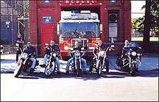 Firefighter William Lake second from left on his Harley